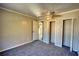 Cozy bedroom featuring neutral walls, gray carpet, and a ceiling fan for added comfort at 11 Grove Ln, Hampton, GA 30228