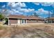 Back exterior view of the cozy home with double glass doors to backyard at 11 Grove Ln, Hampton, GA 30228