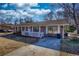 Charming single-story brick home featuring a quaint front porch and a well-maintained front yard with mature trees at 11 Grove Ln, Hampton, GA 30228