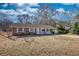 Charming brick home featuring a well-maintained yard and inviting front porch at 11 Grove Ln, Hampton, GA 30228
