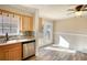 Eat-in kitchen with stainless steel dishwasher and view of backyard through french doors at 11 Grove Ln, Hampton, GA 30228