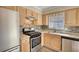 This kitchen features stainless steel appliances, stone backsplash, and light wood cabinets at 11 Grove Ln, Hampton, GA 30228