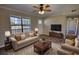 Cozy living room with ample seating, ceiling fan, and an abundance of natural light at 11 Grove Ln, Hampton, GA 30228