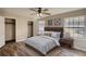 Serene main bedroom with neutral decor, hardwood floors, and ample natural light, creating a tranquil space at 11 Grove Ln, Hampton, GA 30228