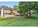 Backyard view of a two-story house with a deck and sunroom overlooking the spacious green lawn at 2010 Barnes Mill Rd, Marietta, GA 30062