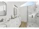 Bright bathroom with dual sinks, a walk-in shower with glass door and white countertops at 2010 Barnes Mill Rd, Marietta, GA 30062