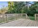 Newly constructed wooden deck with railing overlooks the lush backyard, perfect for outdoor relaxation at 2010 Barnes Mill Rd, Marietta, GA 30062