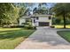 Charming home with a long driveway, well-kept lawn, and lush greenery surrounding the property at 2010 Barnes Mill Rd, Marietta, GA 30062