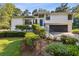 Beautifully landscaped two-story home features a lush lawn, charming shrubbery, and a blue front door at 2010 Barnes Mill Rd, Marietta, GA 30062