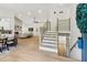 Bright, open-concept living area with modern staircase, beautiful hardwood floors, and stone fireplace at 2010 Barnes Mill Rd, Marietta, GA 30062