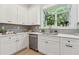Kitchen featuring white cabinetry, stainless appliances, quartz countertops, and backyard views at 2010 Barnes Mill Rd, Marietta, GA 30062