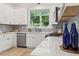 Charming kitchen features white cabinetry, stainless appliances, and a view of the backyard at 2010 Barnes Mill Rd, Marietta, GA 30062