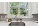 Close up of kitchen sink, quartz countertop and window with backyard views at 2010 Barnes Mill Rd, Marietta, GA 30062