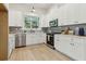 Modern kitchen with white cabinets, updated appliances, and hardwood floors at 2010 Barnes Mill Rd, Marietta, GA 30062