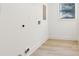Bright laundry room with wood floors and a window bringing in natural light at 2010 Barnes Mill Rd, Marietta, GA 30062
