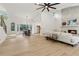 Bright, open-concept living room featuring a stone fireplace, modern fan, and light wood floors at 2010 Barnes Mill Rd, Marietta, GA 30062