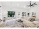 Bright living room with a modern ceiling fan, light wood floors, and access to an outdoor deck at 2010 Barnes Mill Rd, Marietta, GA 30062