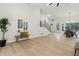 Spacious living room with sleek light wood floors, modern staircase, and access to the dining area at 2010 Barnes Mill Rd, Marietta, GA 30062