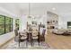 Sunlit living and dining areas feature a stone fireplace and scenic backyard views at 2010 Barnes Mill Rd, Marietta, GA 30062