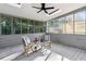 Charming sunroom featuring wood floors, skylights, ceiling fan, and large windows overlooking backyard at 2010 Barnes Mill Rd, Marietta, GA 30062