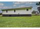 Expansive backyard showing level lawn and home's back exterior with porch at 2122 Browntown Rd, Rockmart, GA 30153
