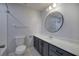 Updated bathroom with a modern vanity, round mirror, and tiled shower for a fresh, clean look at 2122 Browntown Rd, Rockmart, GA 30153