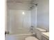 This is a bright bathroom with a white tub and toilet set in a streamlined design at 2122 Browntown Rd, Rockmart, GA 30153