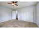 A cozy bedroom with a ceiling fan and an open door leading to another room at 2122 Browntown Rd, Rockmart, GA 30153