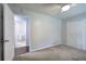 A bedroom with a door leading to the bathroom, closet with white doors and neutral walls at 2122 Browntown Rd, Rockmart, GA 30153
