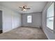 A serene bedroom with a ceiling fan, closet with white doors, and a window for natural light at 2122 Browntown Rd, Rockmart, GA 30153