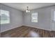Bright dining room features hardwood floors, neutral walls, modern chandelier and abundant natural light at 2122 Browntown Rd, Rockmart, GA 30153