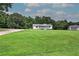 Distant side angle of home with covered porch, deck, and green lawn at 2122 Browntown Rd, Rockmart, GA 30153