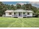 Charming home featuring a covered porch with stylish railings and lush green lawn at 2122 Browntown Rd, Rockmart, GA 30153