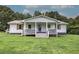 Charming home featuring a covered porch with stylish railings and lush green lawn at 2122 Browntown Rd, Rockmart, GA 30153