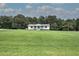 Distant home with covered porch, and green lawn at 2122 Browntown Rd, Rockmart, GA 30153