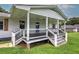 Close-up of covered front porch with black railings, stylish white supports, and wooden shutters at 2122 Browntown Rd, Rockmart, GA 30153
