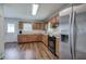 Functional kitchen with wooden cabinets, laminate countertops, stainless steel fridge, and modern appliances at 2122 Browntown Rd, Rockmart, GA 30153