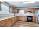 Functional kitchen with wooden cabinets, laminate countertops, stainless steel fridge, and modern appliances at 2122 Browntown Rd, Rockmart, GA 30153