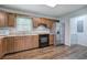 Functional kitchen with wooden cabinets, laminate countertops, stainless steel fridge, and modern appliances at 2122 Browntown Rd, Rockmart, GA 30153