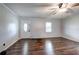 Inviting living room features warm dark hardwood floors, light neutral wall, and bright front door at 2122 Browntown Rd, Rockmart, GA 30153