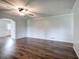Spacious living room with dark hardwood floors, neutral color palette, and a modern ceiling fan at 2122 Browntown Rd, Rockmart, GA 30153