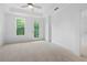 Bright bedroom with neutral carpet, a ceiling fan and tray ceiling, and access to the outside at 340 Olmstead Way # 34, Alpharetta, GA 30022