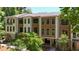 Modern townhome featuring a brick foundation and wood and white siding surrounded by mature trees at 340 Olmstead Way # 34, Alpharetta, GA 30022