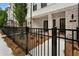 Close-up of a modern townhome facade with brick accents, black trim, and a well-maintained front yard and fence at 340 Olmstead Way # 34, Alpharetta, GA 30022
