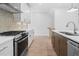 Modern kitchen featuring stainless steel appliances, white cabinets, and a stylish backsplash at 340 Olmstead Way # 34, Alpharetta, GA 30022