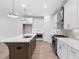 Contemporary kitchen with white cabinetry, a large island, stainless steel appliances, and stylish pendant lighting at 340 Olmstead Way # 34, Alpharetta, GA 30022