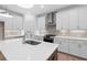Bright kitchen with white cabinets, a large center island, stainless steel appliances, and modern backsplash at 340 Olmstead Way # 34, Alpharetta, GA 30022