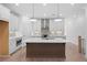 Modern kitchen with white cabinets, quartz countertops, stainless steel appliances, and a central island at 340 Olmstead Way # 34, Alpharetta, GA 30022