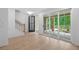 Bright living room with light wood floors, black trim door and staircase, and large sliding doors to the patio at 340 Olmstead Way # 34, Alpharetta, GA 30022