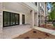 Covered patio with brick flooring, white columns, black trimmed sliding glass doors, and a landscaped yard at 340 Olmstead Way # 34, Alpharetta, GA 30022